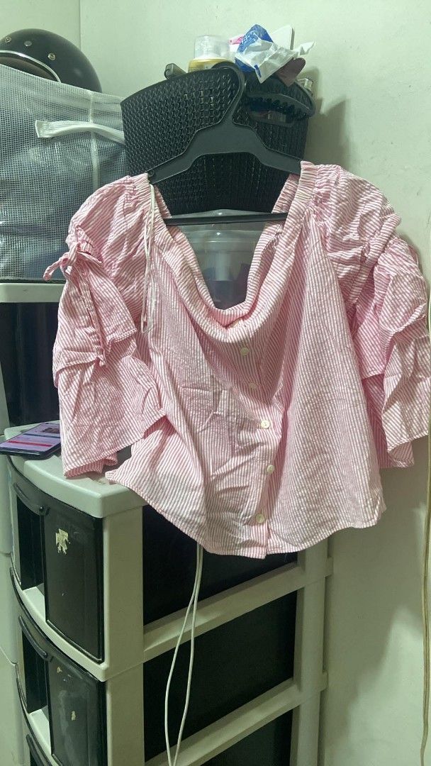 Pink and White Striped Off-Shoulder Top (Category: Blouses) located in Cavite. Submitted by jesusahec44856 (Listing ID 1463967591, Image 1). Description: - Cute pink and white striped pattern - Off-shoulder design - Ruffled sleeves with tie details - Button-down front - Versatile for casual or evening wear - Easily pairs with jeans or shorts.