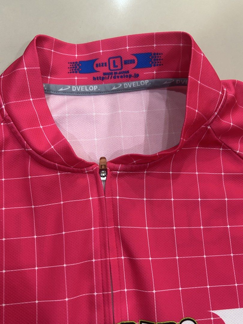 Pink Grid Cycling running pickleball Jersey (Category: Activewear) located in Plaridel. Submitted by ilovebubu28 (Listing ID 1464020918, Image 2). Description: - Pink grid cycling jersey with blue side panels - Features 'DESPERADO' logo on front and back - Full zip closure for easy ventilation - Three back pockets for storage, one with a zipper - Made in Japan for quality craftsmanship - Ideal for your next cycling , running adventure.