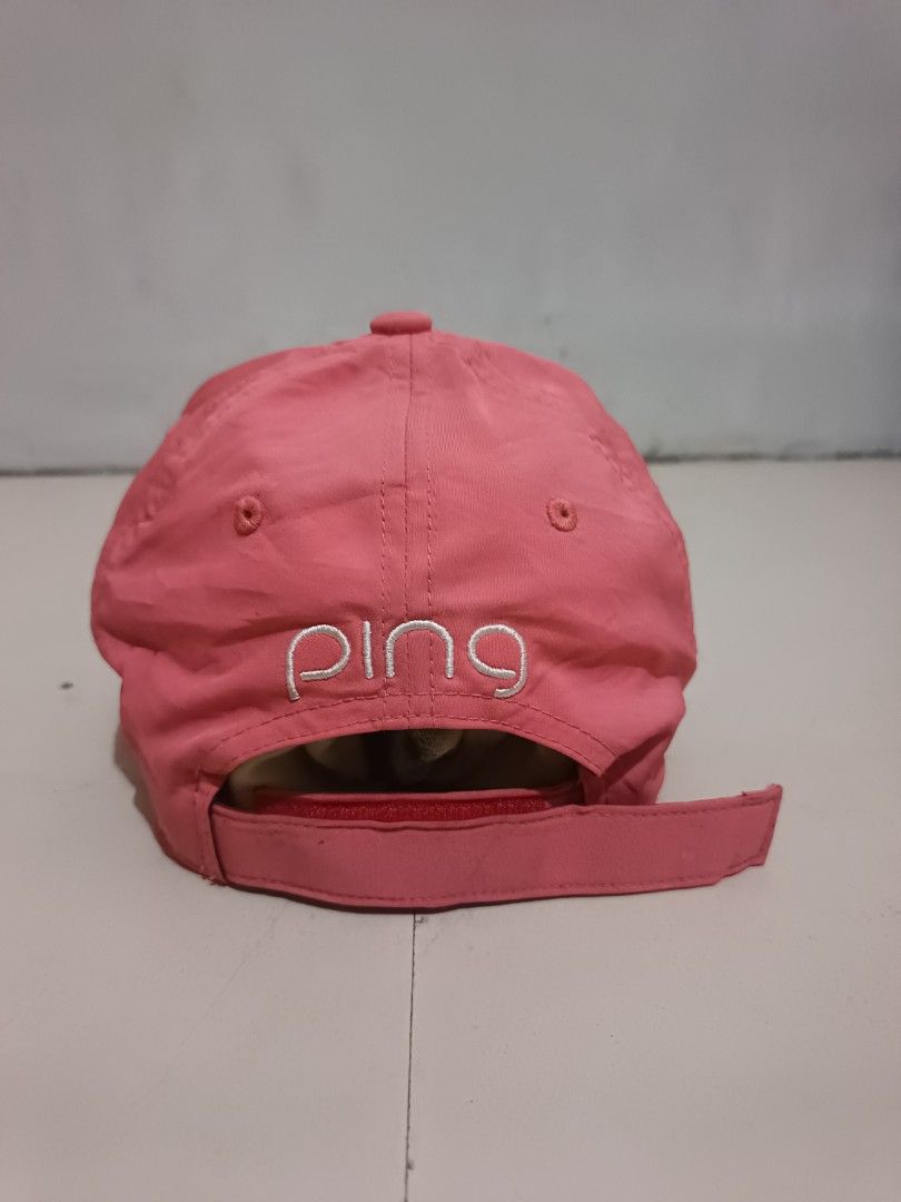 Pink Ping Golf Cap (Category: Caps & Hats) located in Manila. Submitted by unplnndco. (Listing ID 1464046648, Image 3). Description: - Pink Ping cap -Condition: 9/10 -Colorate: 9/10 -Issue: shown on last 2 picture - Embroidered Ping logo on front and back - Perforated sides for breathability - Adjustable strap for a custom fit - Made with 87% Polyester and 13% Spandex - Ideal for golf or everyday casual wear.