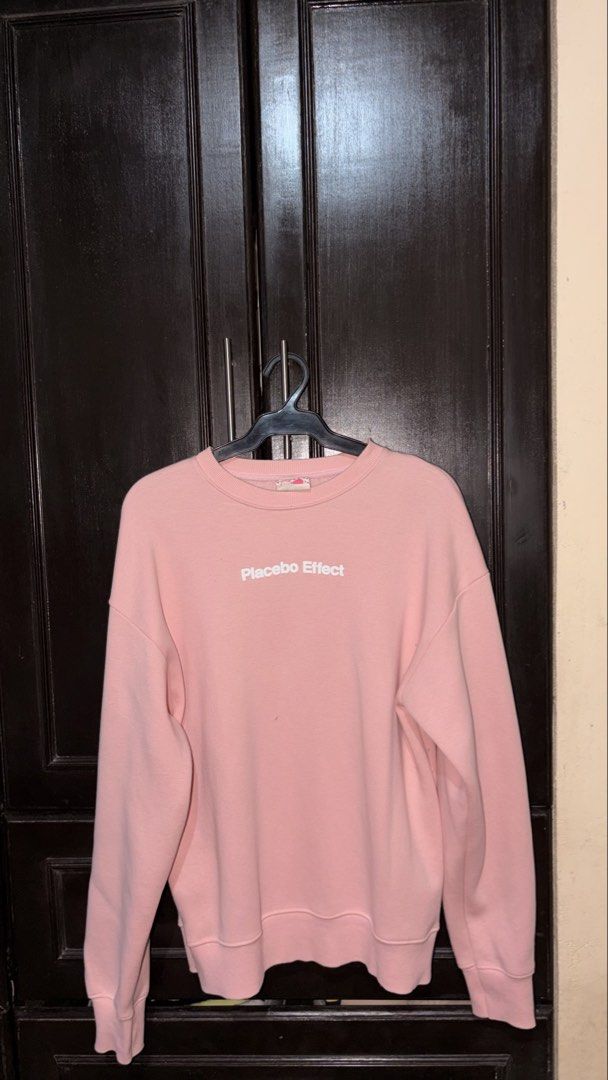 Pink "Placebo Effect" Crewneck Sweatshirt (Category: Coats, Jackets and Outerwear) located in Manila. Submitted by keenfox-84bb (Listing ID 1464025079, Image 1). Description: - Pink crewneck sweatshirt - Features white 'Placebo Effect' text on the front - Designed for comfort and casual style - Ideal for everyday wear - Versatile: pairs well with jeans or shorts.