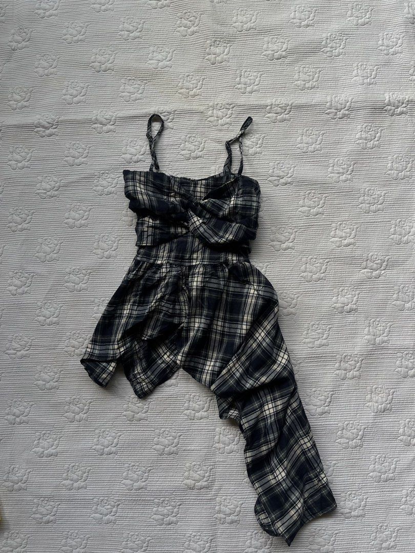 Plaid Twist Front Strappy Dress (Category: Dresses) located in Alabel. Submitted by geragarhea13830 (Listing ID 1463963738, Image 1). Description: - Trendy black and white plaid pattern - Flattering twist front detail on the bodice - Comfortable strappy design with a smocked back - Stylish asymmetrical hemline - Made from lightweight fabric - Versatile for casual outings or evening events.