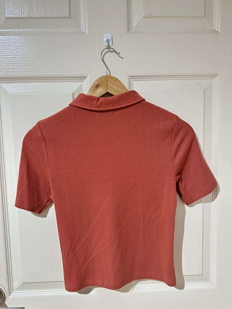 Pomelo Ribbed Collared Button-Up Crop Top (Category: Shirts) located in Manila. Submitted by ktyyycloset (Listing ID 1463957951, Image 2). Description: - Coral pink ribbed crop top from Pomelo - Short sleeves - Collared neckline - Button-up front - Keyhole detail - Comfortable and stylish for casual outings.
