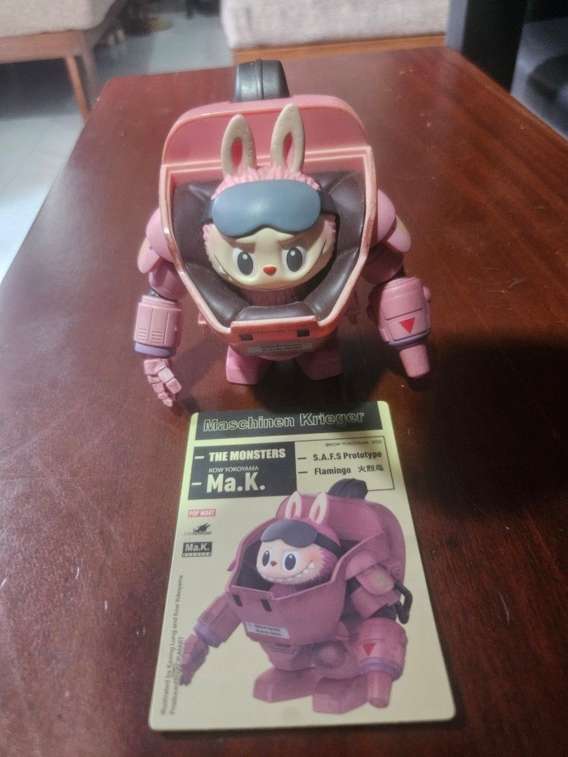 Pop Mart x Kasing Bunny Robot Figure (Category: Designer & Blind Box Toys) located in Manila. Submitted by declutterhopper (Listing ID 1422611717, Image 3). Description: - Pink bunny robot collectible figure - Includes matching red scale - Detailed design with bunny face and robot body - Features Pop Mart logo and model information - Ideal for collectors.