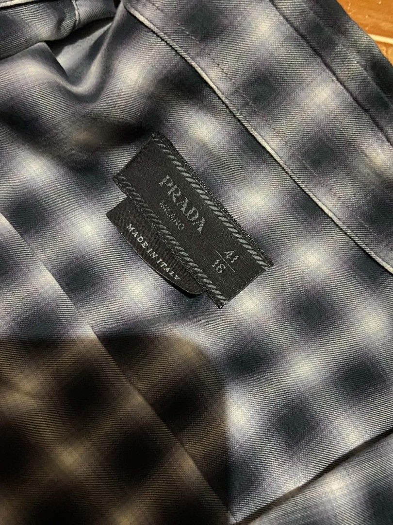 PRADA Blue/Navy/White Check Button-Down Longsleeve Size 41/16 (Category: Coats, Jackets and Outerwear) located in Paranaque City. Submitted by jnthn.c (Listing ID 1464052841, Image 3). Description: PRADA Blue/Navy/White Plaid Button-Down Longsleeve Size 41/16 on Tag Actual Size: 30 x 19 fits on Large to XL Issue: Nagdikit yung Tag need iFlashlight para mabasa, Need wash & Need plantsa.