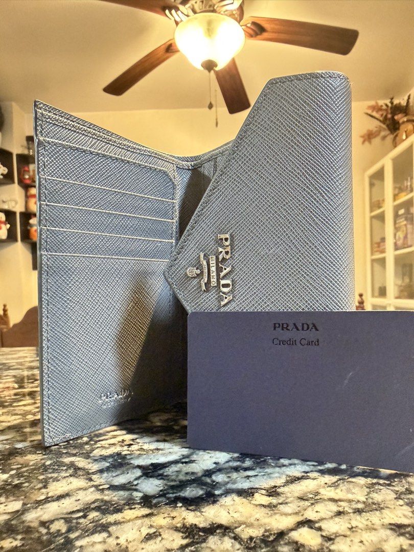 Prada Saffiano Leather Wallet Grey (Category: Wallets & Card holders) located in Manila. Submitted by karlvincen05232 (Listing ID 1464092879, Image 2). Description: - Authentic Prada Wallet - Color: Grey - Material: Saffiano Leather - Style: Envelope with Snap Closure - Features: Multiple Card Slots, Zipped Coin Pocket - Includes: Original Box and Dust Bag.