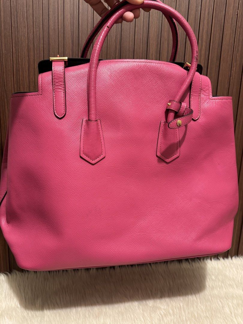 Prada Saffiano Tote Bag Pink (Category: Luxury Bags & Wallets) located in Cauayan City . Submitted by espiritucj (Listing ID 1464082172, Image 3). Description: Thrifted - - Prada tote bag - Vibrant pink Saffiano leather - Iconic Prada logo on front - Interior: zip pocket and central compartment - Gold-tone hardware - Comes with Prada inner pouch - Ideal for everyday use or travel.