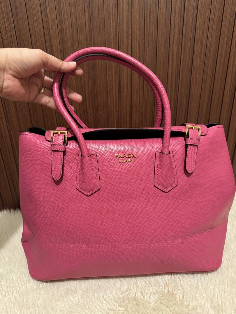 Prada Saffiano Tote Bag Pink (Category: Luxury Bags & Wallets) located in Cauayan City . Submitted by espiritucj (Listing ID 1464082172, Image 2). Description: Thrifted - - Prada tote bag - Vibrant pink Saffiano leather - Iconic Prada logo on front - Interior: zip pocket and central compartment - Gold-tone hardware - Comes with Prada inner pouch - Ideal for everyday use or travel.
