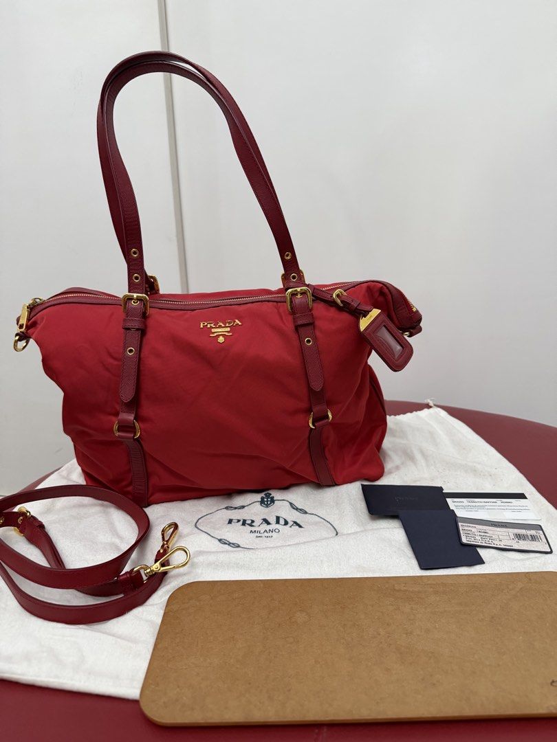 Prada Tessuto Gaufre Tote Bag Red (Category: Tote Bags) located in Cagayan de Oro. Submitted by decluttergoddess (Listing ID 1464056051, Image 1). Description: PRADA TESSUTO + SAFFIANO ROSSO 2-WAY TOTE Elegant and versatile Prada tote in classic Rosso Red, crafted in signature Tessuto nylon with Saffiano leather trim. Can be carried by hand or worn crossbody/shoulder. ❤️ DETAILS: • Prada Milano • Tessuto Nylon + Saffiano Leather • Color: Rosso / 