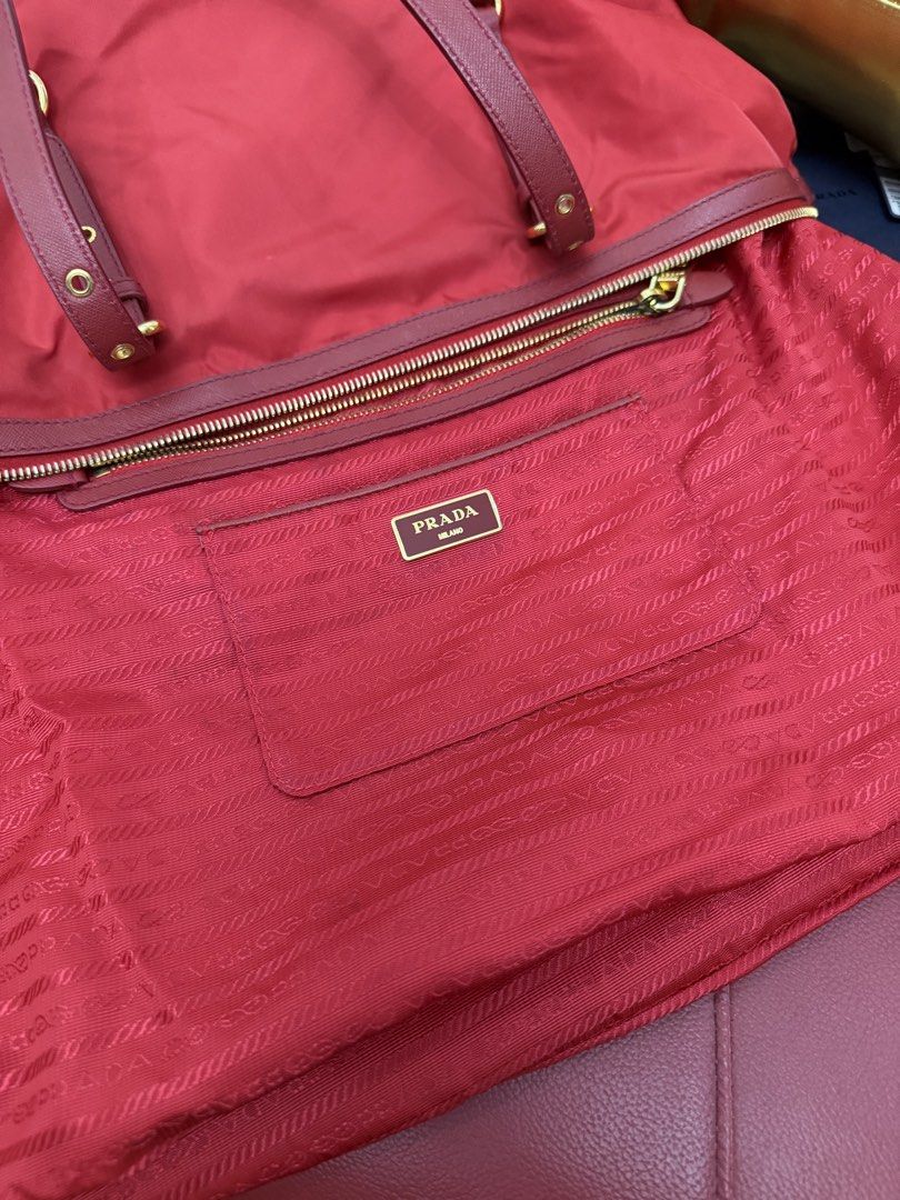 Prada Tessuto Gaufre Tote Bag Red (Category: Tote Bags) located in Cagayan de Oro. Submitted by decluttergoddess (Listing ID 1464056051, Image 3). Description: PRADA TESSUTO + SAFFIANO ROSSO 2-WAY TOTE Elegant and versatile Prada tote in classic Rosso Red, crafted in signature Tessuto nylon with Saffiano leather trim. Can be carried by hand or worn crossbody/shoulder. ❤️ DETAILS: • Prada Milano • Tessuto Nylon + Saffiano Leather • Color: Rosso / 