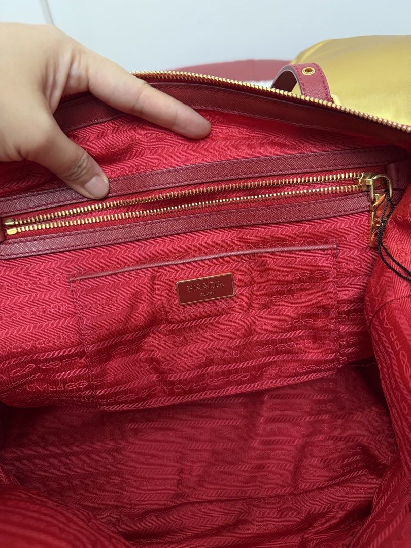 Prada Tessuto Gaufre Tote Bag Red (Category: Tote Bags) located in Cagayan de Oro. Submitted by decluttergoddess (Listing ID 1464056051, Image 2). Description: PRADA TESSUTO + SAFFIANO ROSSO 2-WAY TOTE Elegant and versatile Prada tote in classic Rosso Red, crafted in signature Tessuto nylon with Saffiano leather trim. Can be carried by hand or worn crossbody/shoulder. ❤️ DETAILS: • Prada Milano • Tessuto Nylon + Saffiano Leather • Color: Rosso / 