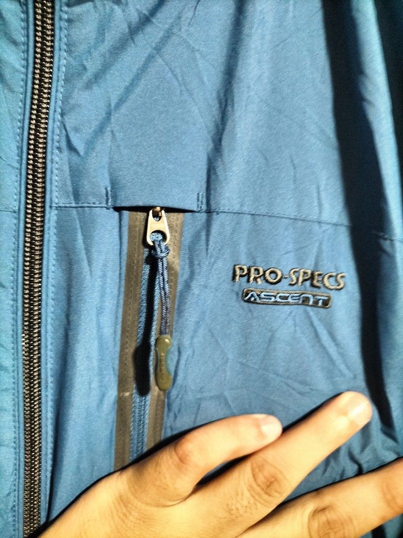 PRO-SPECS ASCENT Blue Hooded Jacket (Category: Coats, Jackets and Outerwear) located in Valencia. Submitted by cabisaythriftshop (Listing ID 1463986224, Image 2). Description: - PRO-SPECS ASCENT blue hooded jacket - Zipper closure - Multiple zippered pockets - Grey mesh inner lining - Ideal for outdoor activities - Size: 100 Prospecs Water Resistance Xlarge 29L*24W Excellent Condition.