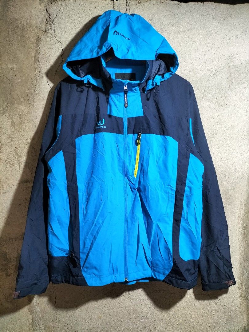 PROSPECS Blue & Navy Hooded Outdoor Jacket (Category: Coats, Jackets and Outerwear) located in Valencia. Submitted by cabisaythriftshop (Listing ID 1464022198, Image 1). Description: - PROSPECS hooded jacket in blue and navy. - Ideal for outdoor activities, hiking, or casual wear. - Features a full zip front closure. - Adjustable hood for customizable coverage. - Equipped with multiple pockets for convenient storage. Prospecs Water Resistance Xla