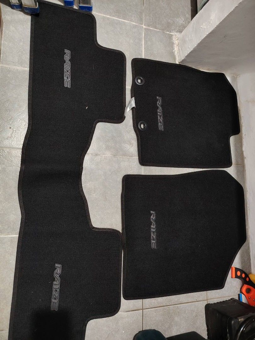 RAIZE Car Stock Matting Complete Set (Category: Upholstery, Seatcovers and Other Interior Parts and Accessories) located in Quezon City. Submitted by johnsunga (Listing ID 1464050671, Image 1). Description: - Stock/Original matting set for Toyota Raize - Includes/free custom fit floor mat set for Toyota Raize front and rear / also fit for wigo g - Set 1: Black carpet with RAIZE logo - Set 2: Brown carpet mats - Protects car interior from dirt and