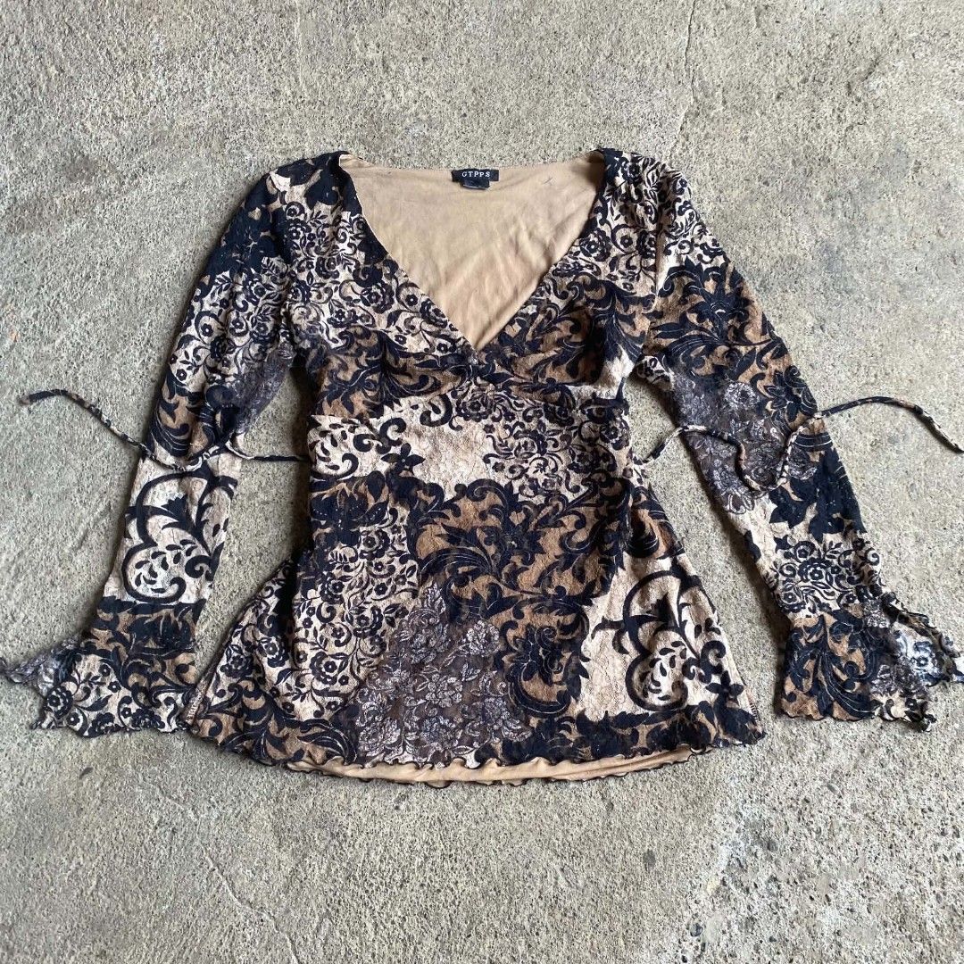 Vintage Whimsygoth top ✨ (Category: Longsleeves) located in Davao. Submitted by calli_2219 (Listing ID 1463967992, Image 1). Description: - Chic brown and black floral print top - Long sleeves with stylish flared cuffs - Flattering V-neckline with adjustable tie waist - Elegant sheer overlay with a comfortable solid lining - Unique all-over pattern - Perfect for a night out or a casual day look Hearing offers for now ✨ Message me your offers 🫶🏻