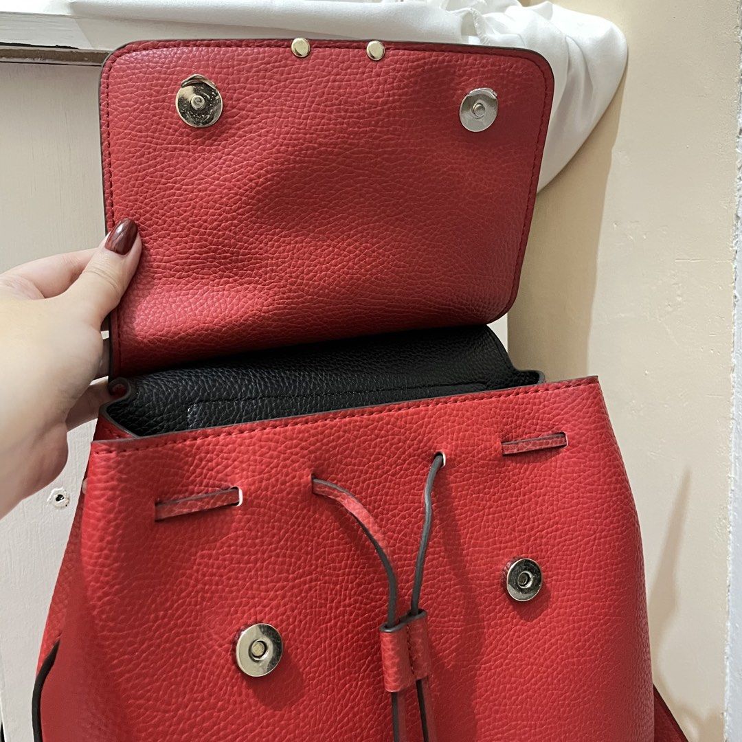 Red Guess Backpack (Category: Backpacks) located in Quezon City. Submitted by lovedbythea___ (Listing ID 1464035699, Image 3). Description: BUY AT UR OWN RISK‼️ padala from US, idk if orig orig swipe to see flaws: this was used only once, idk lang po kung may paint na dumikit dito while in transit .