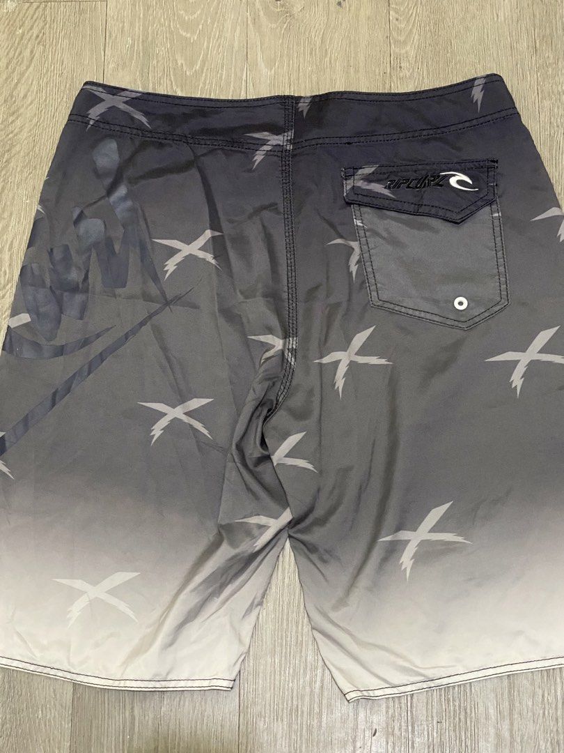 Rip Curl Mick Fanning Board Shorts Size 36 (Category: Swim Trunks & Board Shorts) located in Manila. Submitted by owabaet12 (Listing ID 1464057626, Image 2). Description: - Rip Curl board shorts - Size: 36 - Color: Grey gradient with white 'X' graphics - Collaboration: Mick Fanning - Features: Back pocket with velcro closure, drawstring waist - Ideal for: Swimming, surfing.