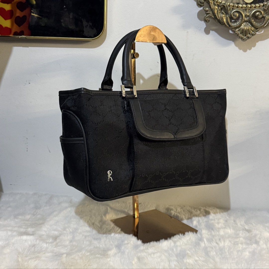 Roberta di Camerino Black Monogram Canvas handbag (Category: Luxury Bags & Wallets) located in Rizal. Submitted by houseofbell (Listing ID 1464116930, Image 2). Description: - Authentic Roberta di Camerino tote bag - Signature monogram canvas with leather trim - Front flap pocket - Side pockets - Interior zip pocket and compartments Canvas and genuine leather handle Dimensions 13x7.5 inches .
