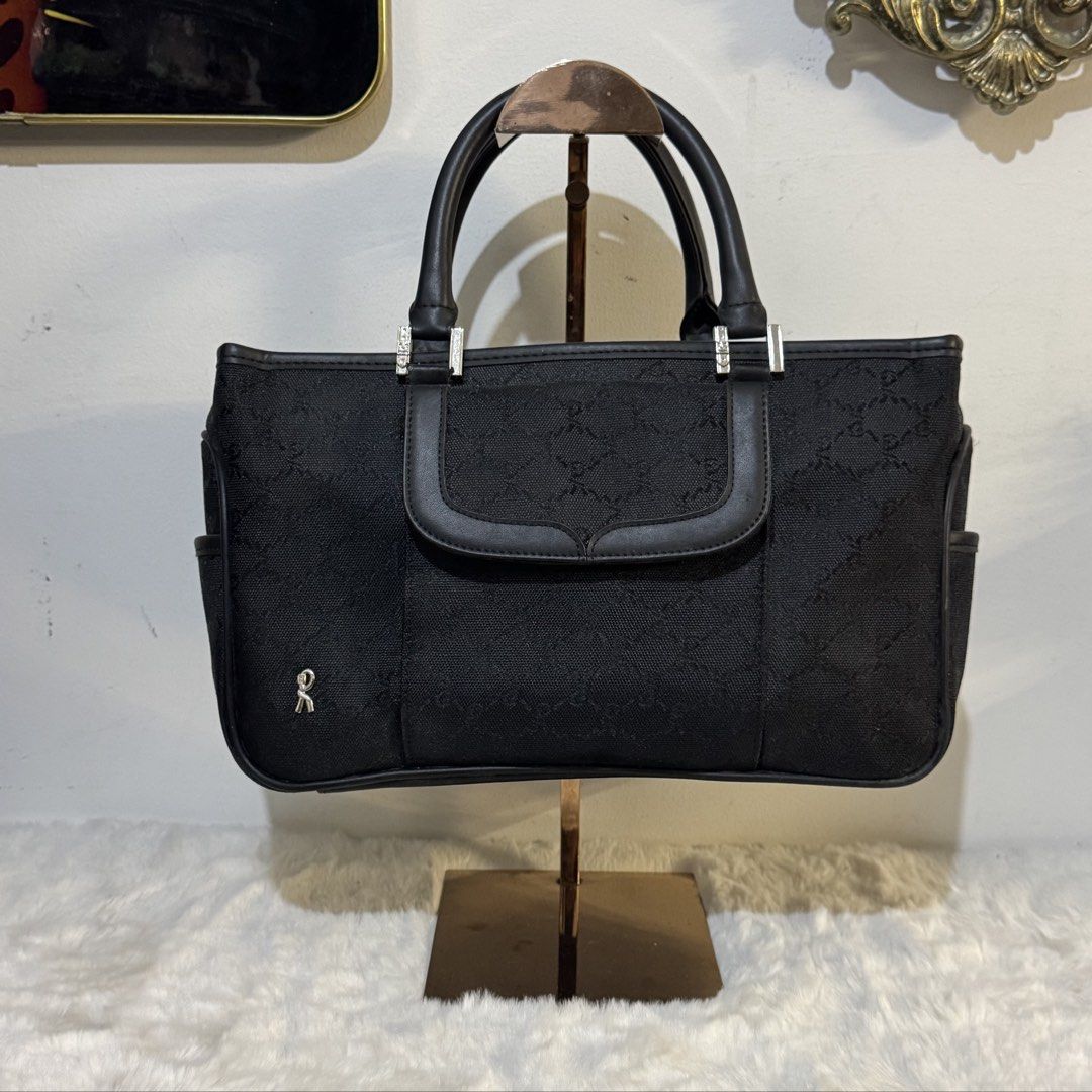Roberta di Camerino Black Monogram Canvas handbag (Category: Luxury Bags & Wallets) located in Rizal. Submitted by houseofbell (Listing ID 1464116930, Image 1). Description: - Authentic Roberta di Camerino tote bag - Signature monogram canvas with leather trim - Front flap pocket - Side pockets - Interior zip pocket and compartments Canvas and genuine leather handle Dimensions 13x7.5 inches .