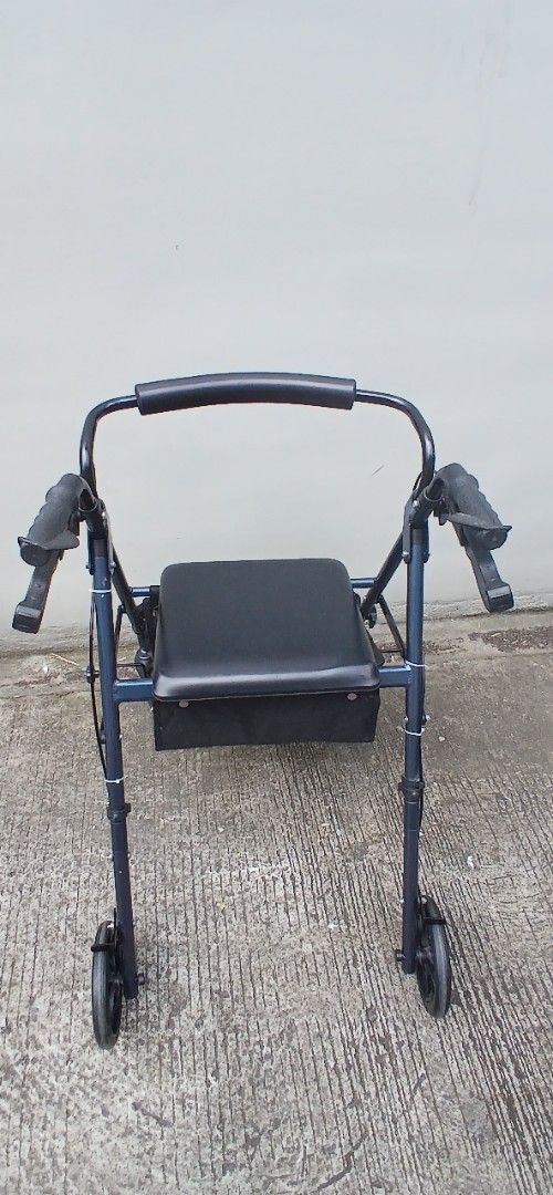 Rollator (Category: Mirrors) located in Marikina City. Submitted by darthvader888 (Listing ID 1463970126, Image 3). Description: - Dark blue walker with built-in seat - Equipped with wheels for easy mobility - Comfortable padded handles - Convenient storage bag under the seat - Folds for compact storage - Ideal for enhancing independence and getting around no issues.