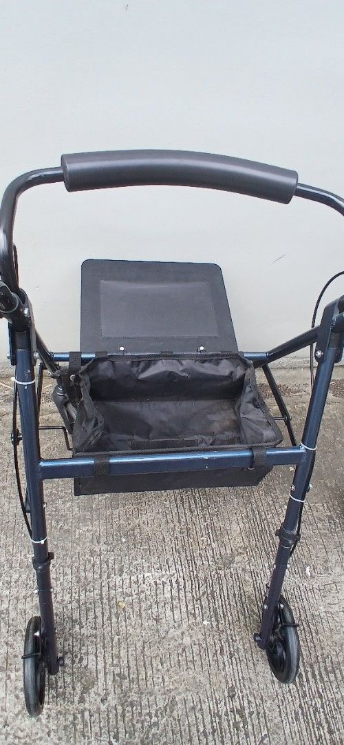 Rollator (Category: Mirrors) located in Marikina City. Submitted by darthvader888 (Listing ID 1463970126, Image 2). Description: - Dark blue walker with built-in seat - Equipped with wheels for easy mobility - Comfortable padded handles - Convenient storage bag under the seat - Folds for compact storage - Ideal for enhancing independence and getting around no issues.