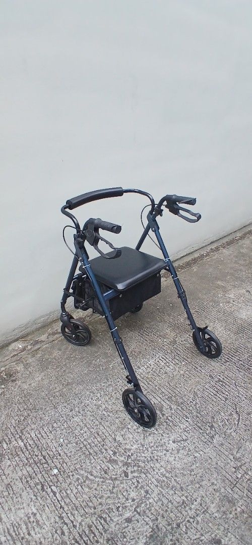 Rollator (Category: Mirrors) located in Marikina City. Submitted by darthvader888 (Listing ID 1463970126, Image 1). Description: - Dark blue walker with built-in seat - Equipped with wheels for easy mobility - Comfortable padded handles - Convenient storage bag under the seat - Folds for compact storage - Ideal for enhancing independence and getting around no issues.