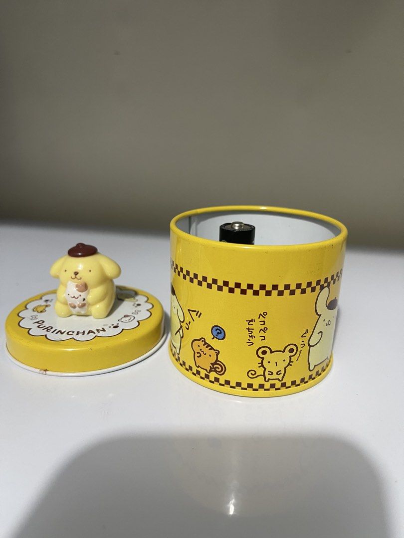 Sanrio Pompompurin Tin Can with Figurine (Category: Vintage Collectibles) located in Manila. Submitted by dstrangerthings (Listing ID 1464064321, Image 2). Description: - Adorable Pompompurin tin can with a matching figurine on the lid. - Features charming Pompompurin and friends graphics all around. - Ideal for storing small treasures or as a delightful collectible. - Authentically made in Japan. - Compact size: approximately 3 inches tall..