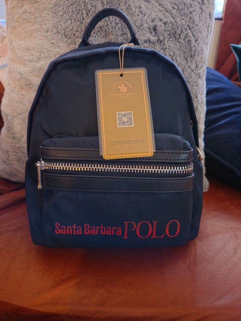 Santa Barbara Polo backpack (Category: Backpacks) located in Manila. Submitted by mybabyprelovedstuff (Listing ID 1463974644, Image 1). Description: - Brand: Santa Barbara Polo & Racquet Club - Color: Black with red logo - Features: Front zip pocket, main compartment, inner zip pocket - Straps: Adjustable - Ideal for: Everyday use, travel small bag.