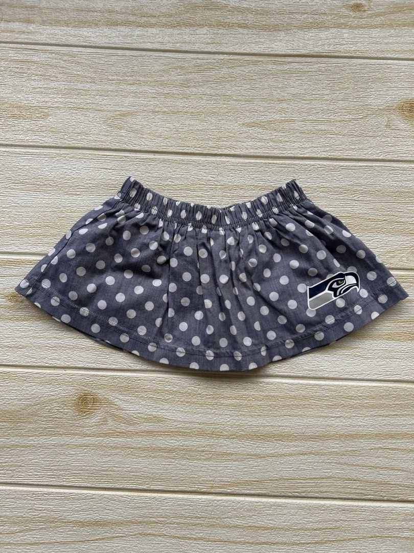 Seahawks Polka skirt (Category: Babies & Kids Fashion) located in Cebu City. Submitted by yjainani (Listing ID 1464029692, Image 1). Description: grey polka dot baby girl skirt featuring the Seattle Seahawks team logo near the hem.