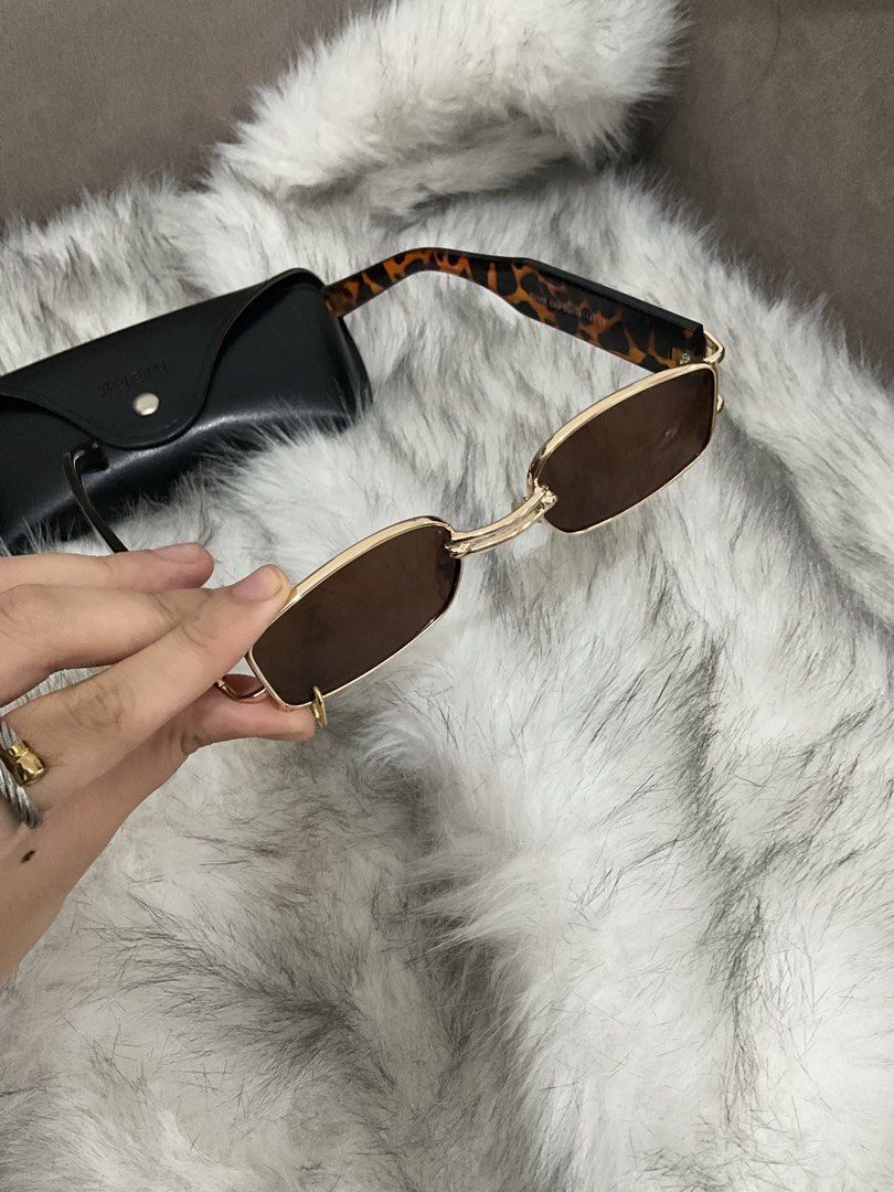 SHEIN Rectangular Sunglasses with Case (Category: Sunglasses & Eyewear) located in Manila. Submitted by francine.edit (Listing ID 1464019107, Image 2). Description: - Gold frame rectangular sunglasses - Brown tinted lenses - Tortoiseshell pattern on the arms - Comes with a black SHEIN case - Ideal for everyday wear or as a fashion accessory.