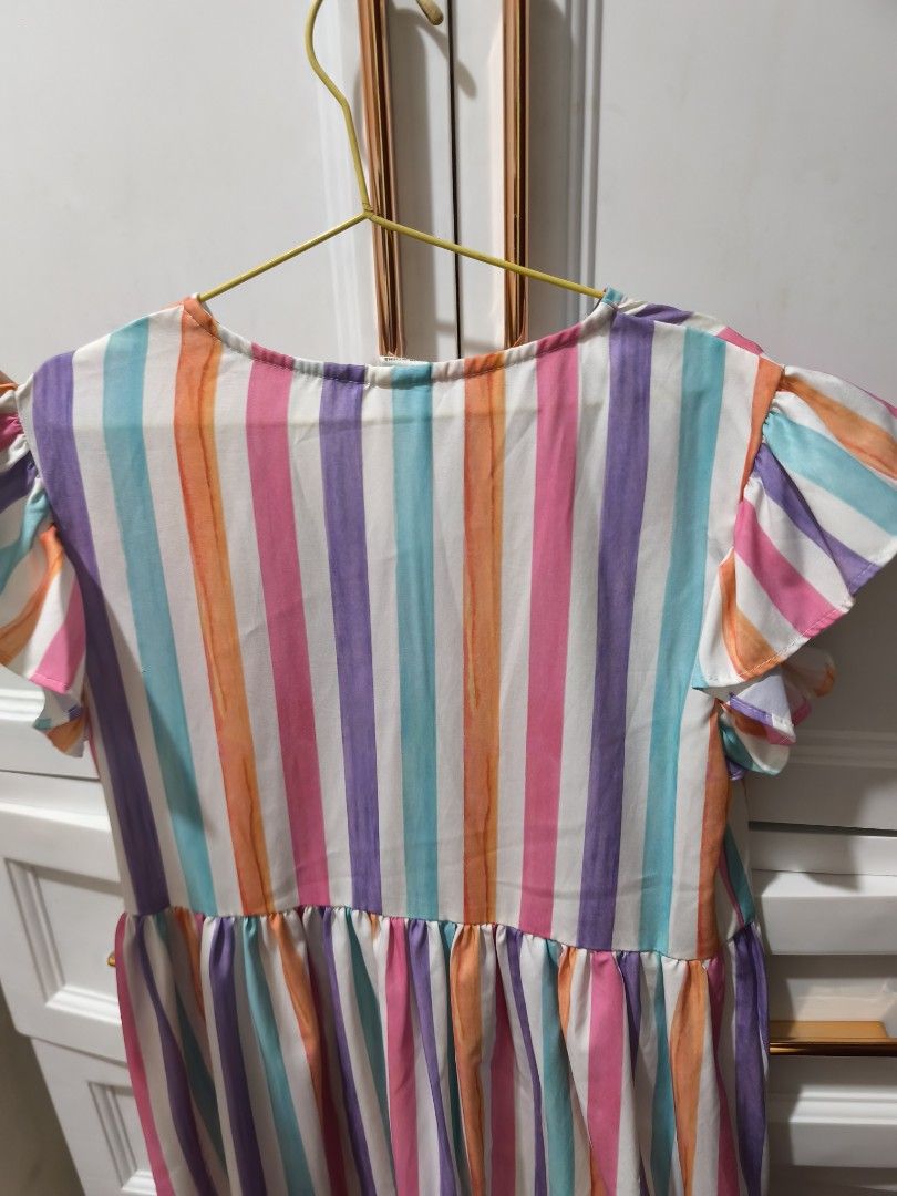 SHEIN Striped Button-Front Flutter Sleeve Dress Size 10Y (Category: Babies & Kids Fashion) located in Manila. Submitted by glendamae16 (Listing ID 1464092018, Image 3). Description: - Cute striped dress from SHEIN - Size: 10Y - Features flutter sleeves - Button-front design - Bright and fun colors, ideal for summer - Elasticated waist for a comfortable fit - Perfect for casual outings or parties.
