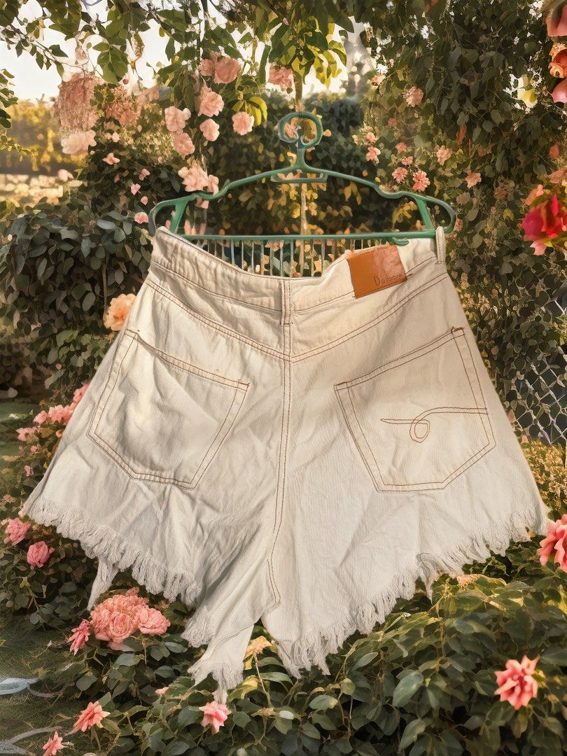 SHORT: a white denim short Large size on tag button fly. (Category: Shorts) located in Calumpit. Submitted by painkiller2526 (Listing ID 1463980974, Image 2). Description: These are white denim shorts featuring an asymmetric cross-over waistband and distressed frayed hems. Message me to those who are interested MOP: Gcash GoTyme MariBank SF: shoulder by the buyer.