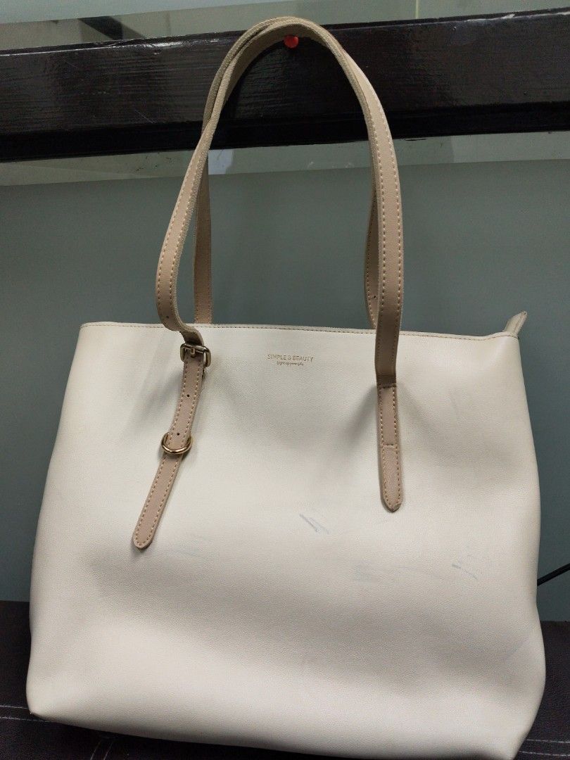 SIMPLE & BEAUTY Cream Tote Bag (Category: Tote Bags) located in Paranaque City. Submitted by joycelyn10 (Listing ID 1463952705, Image 1). Description: - Cream colored tote bag from SIMPLE & BEAUTY - Features two tan straps - Plenty of life left, perfect for everyday use - Visible stain see on the picture.