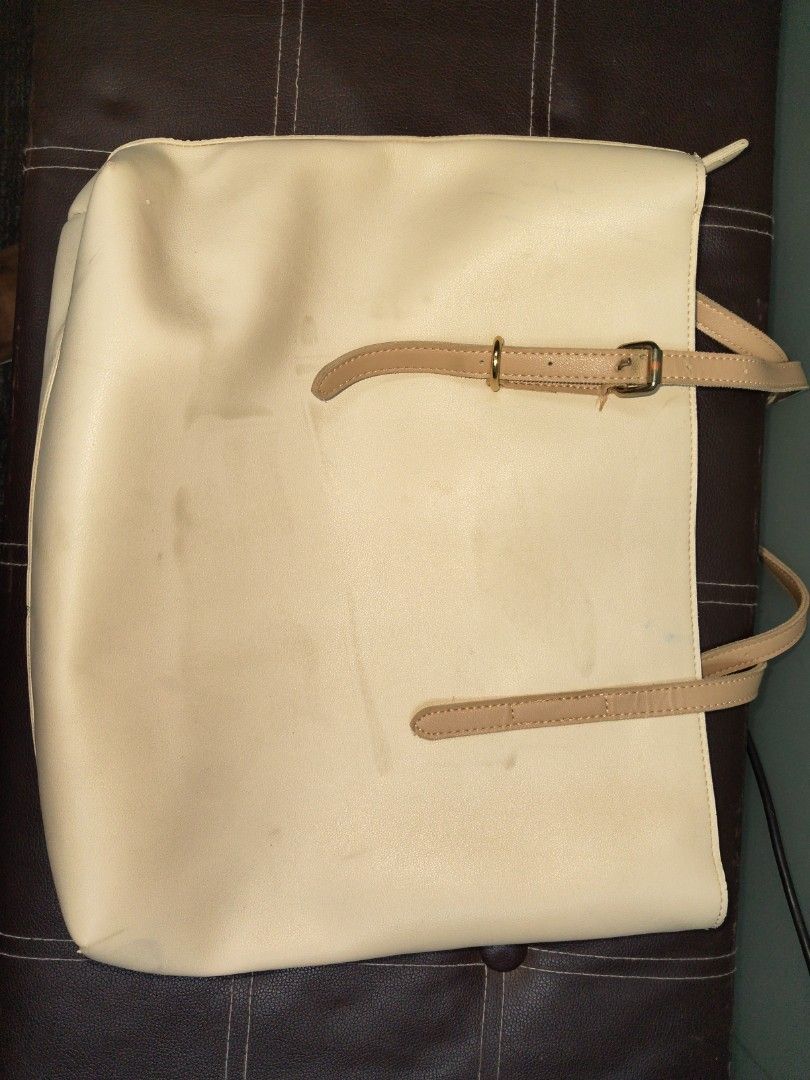 SIMPLE & BEAUTY Cream Tote Bag (Category: Tote Bags) located in Paranaque City. Submitted by joycelyn10 (Listing ID 1463952705, Image 3). Description: - Cream colored tote bag from SIMPLE & BEAUTY - Features two tan straps - Plenty of life left, perfect for everyday use - Visible stain see on the picture.