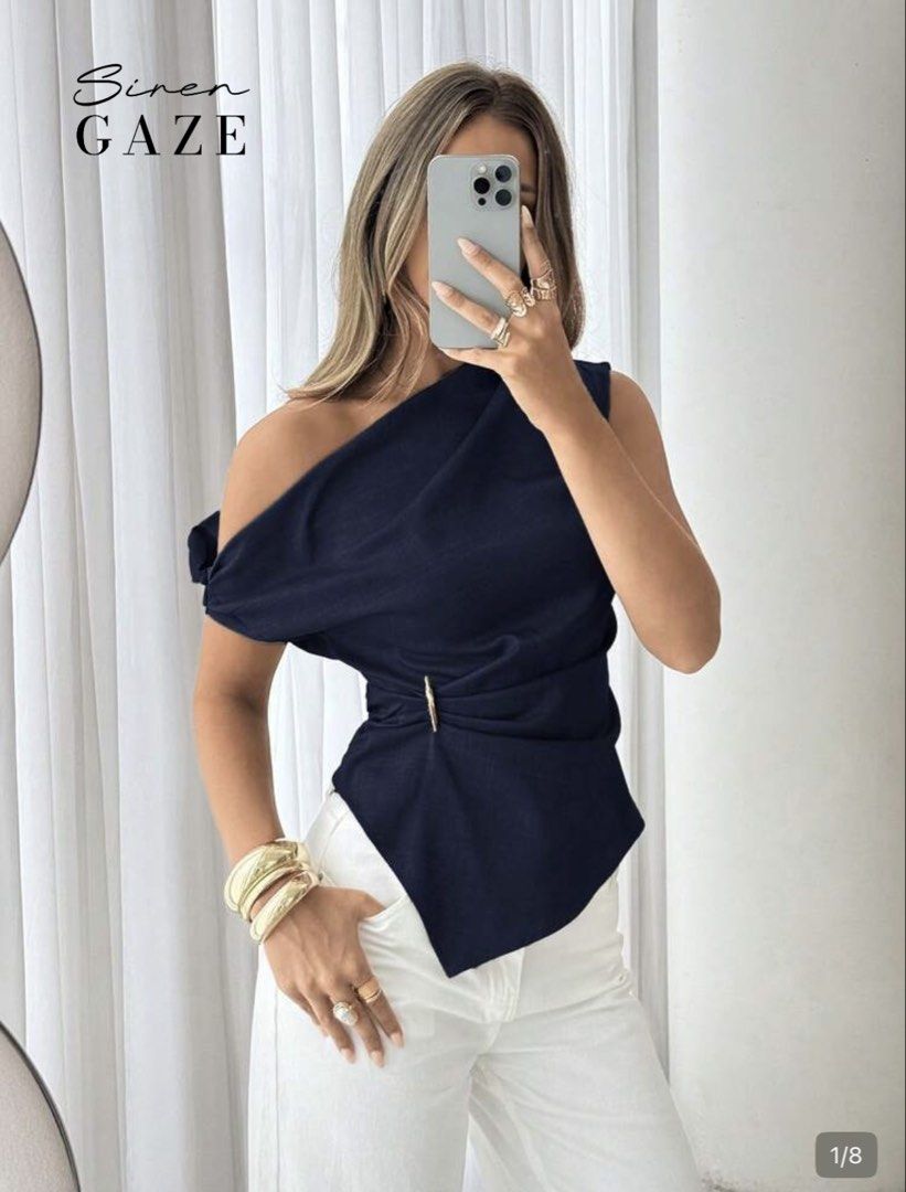 Siren Gaze Navy One-Shoulder Draped Top (Category: Sleeveless) located in Manila. Submitted by silver.declutterzz (Listing ID 1463949295, Image 1). Description: - Stylish navy one-shoulder top - Elegant draped, asymmetrical hem - Chic gold buckle detail at the waist - Fabric with a beautiful flow - Versatile: looks great with white pants or skirts - Ideal for night outs or special occasions.