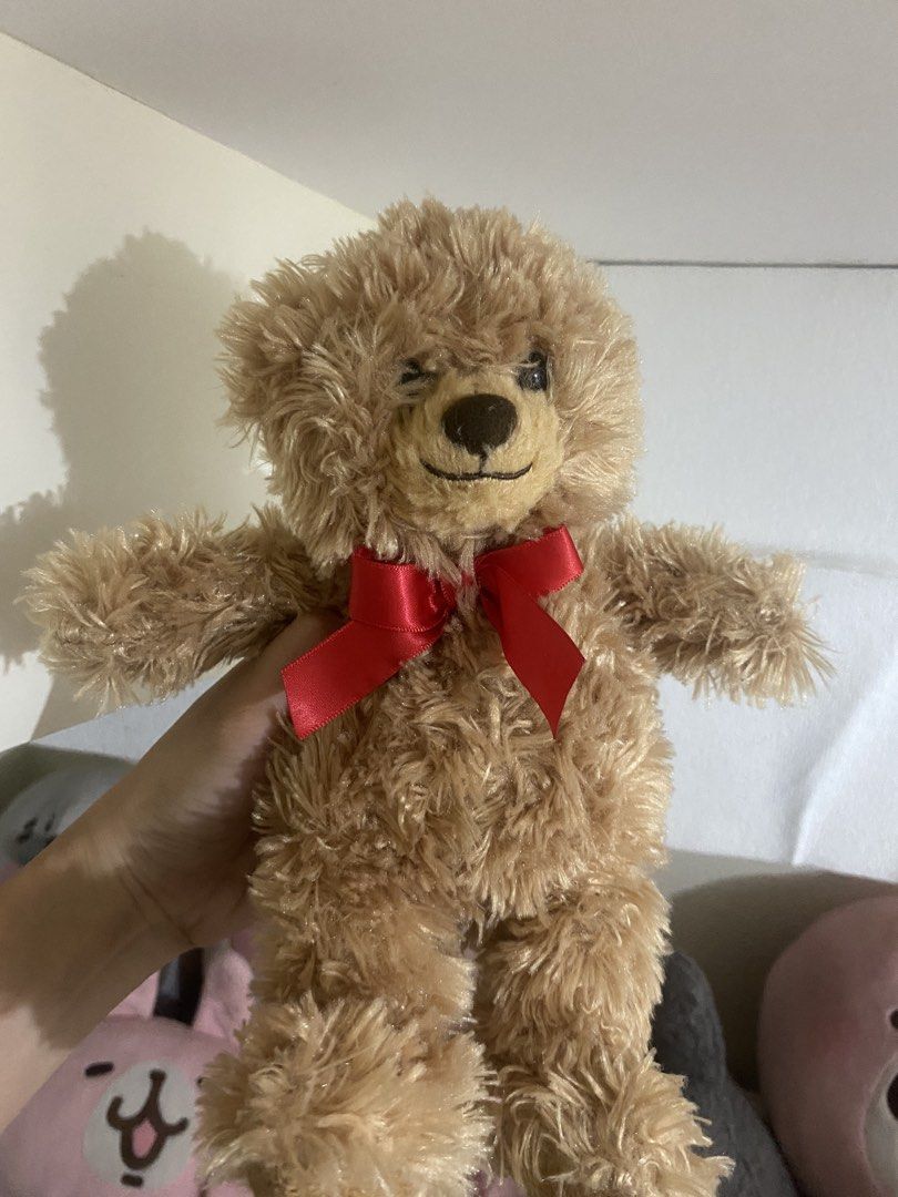 small Cute Brown Teddy Bear with Red Bow (Category: Plushies & Soft Toys) located in Manila. Submitted by faerikhae (Listing ID 1464089246, Image 1). Description: - Super soft and fluffy teddy bear - Adorable red ribbon around its neck - Ideal for cuddling or as a charming decoration - Wonderful gift for teddy bear lovers - Eager to find its new forever home!.