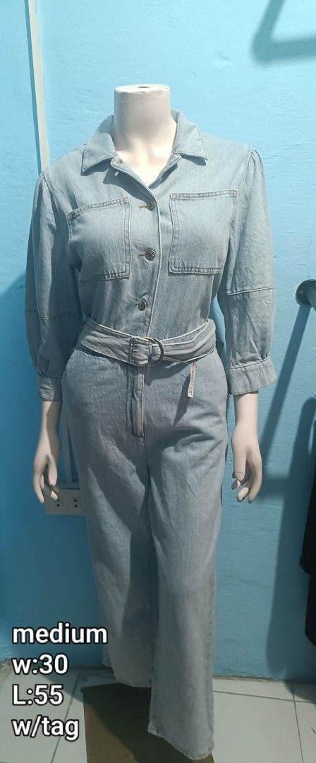Soft Denim Jumpsuit with Belt (Category: Jumpsuits) located in Quezon City. Submitted by davidclothing (Listing ID 1464071607, Image 1). Description: - Light wash denim jumpsuit - Collared neckline - Button-up front - Matching fabric belt included - Puffed sleeves with elastic cuffs - Wide leg pants - Brand new with tags attached.