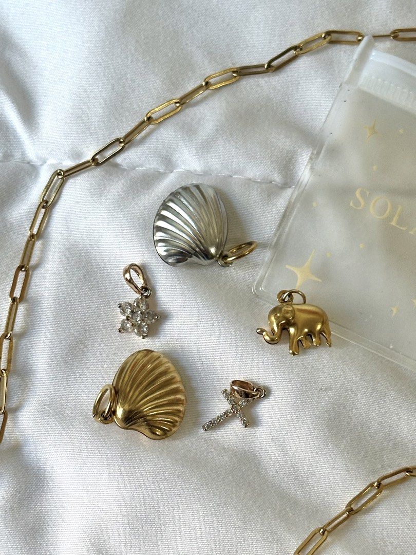 Solasta Gold Charm necklace (Category: Necklaces) located in Manila. Submitted by brownbutterlatte (Listing ID 1463962151, Image 1). Description: Length is 20” - 5 charms included with solasta pouch Used once in singapore! Note: missing carabiner. RFS: not my style anymore. .