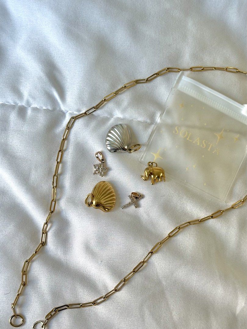 Solasta Gold Charm necklace (Category: Necklaces) located in Manila. Submitted by brownbutterlatte (Listing ID 1463962151, Image 2). Description: Length is 20” - 5 charms included with solasta pouch Used once in singapore! Note: missing carabiner. RFS: not my style anymore. .