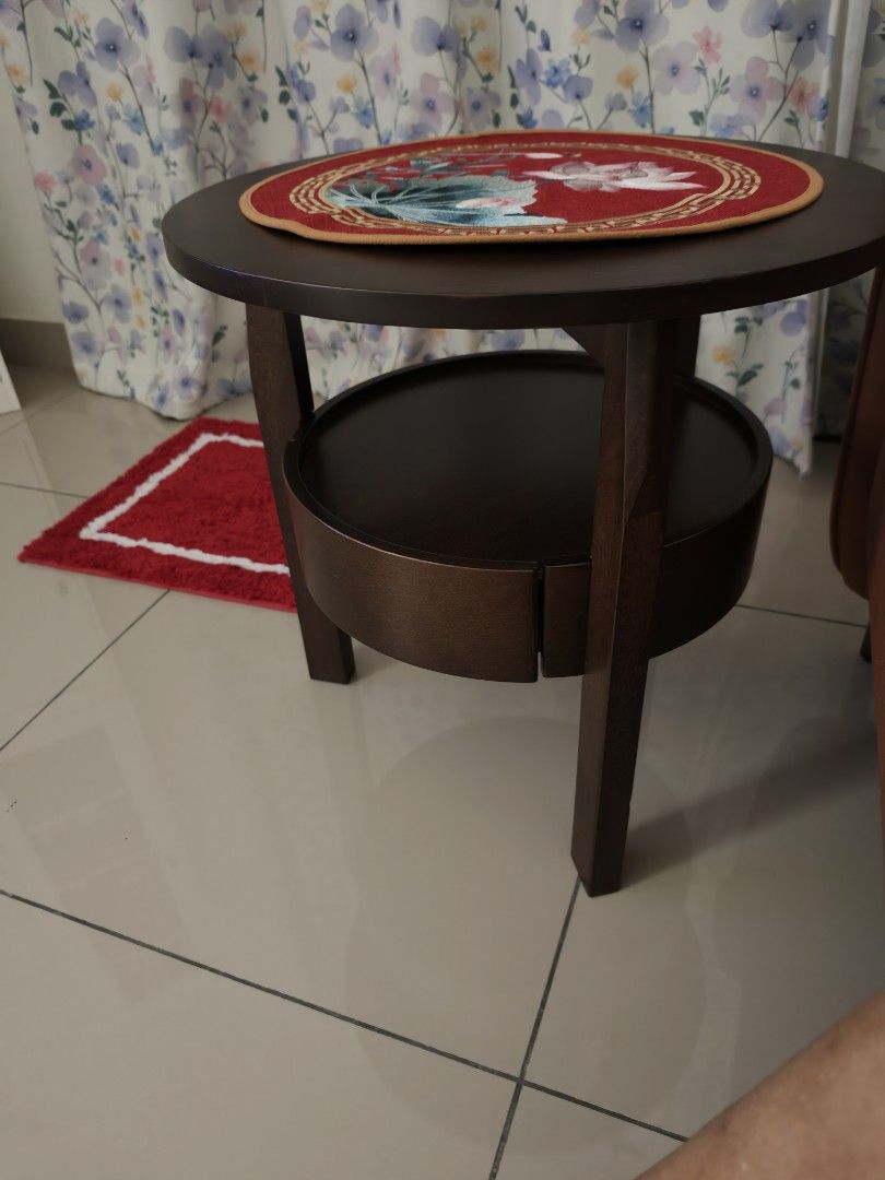 Solid Wood Round Side Table (Category: Tables & Sets) located in Nusajaya. Submitted by sanchella73 (Listing ID 1464112373, Image 1). Description: - Dark wood round side table - Features a lower shelf for extra storage - Perfect for living rooms or bedrooms.