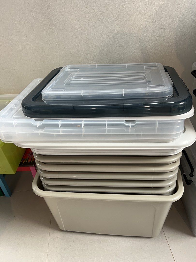 Stackable Clear Storage Boxes with Lids (Category: Storage Boxes & Baskets) located in Singapore. Submitted by origination (Listing ID 1464033653, Image 1). Description: - $50 for ALL 12 storage boxes - only used once for moving house - Set of clear storage boxes with lids - Stackable design for efficient storage - Includes various sizes - Lid colors: some dark grey, some clear - Largest box is light beige - Ideal for organizing home or garage sp