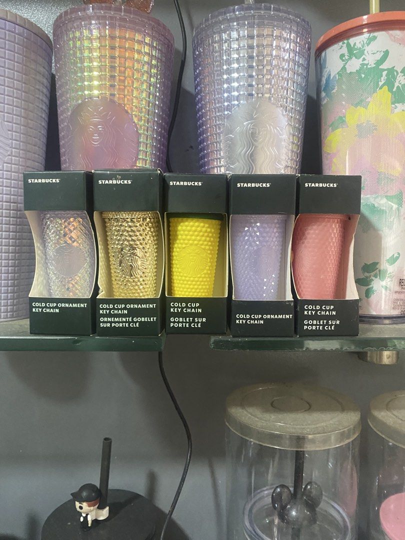 Starbucks Cold Cup Ornament Keychains - Various Colors (Category: Character Goods) located in Paranaque City. Submitted by jayisnottyfound (Listing ID 1463991393, Image 1). Description: - Adorable Starbucks cold cup ornament keychains - Mini replicas of the popular Starbucks cold cups - Available colors: Clear, Gold, Yellow, Lavender, Pink - Perfect for decorating your bag or keys - Collect all the cute designs!.