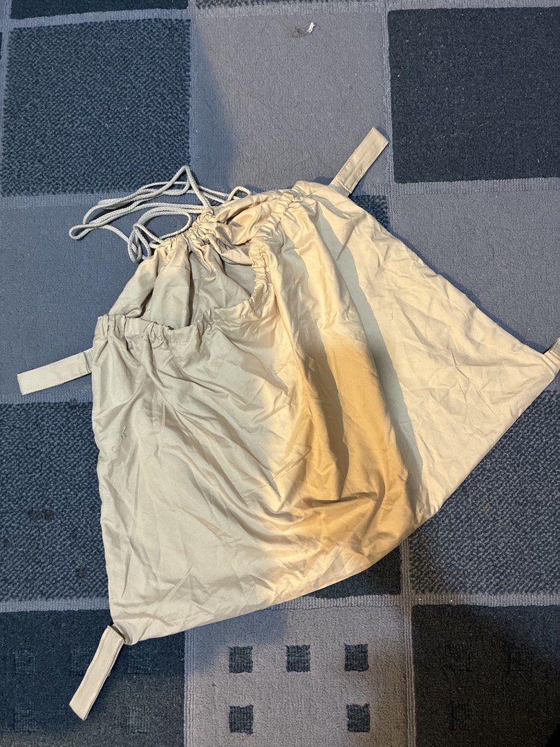Stroller Organizer Bag (Category: Other Babies Going Out Needs) located in Lapu Lapu. Submitted by curated.buys (Listing ID 1464077925, Image 1). Description: - Beige drawstring bag - Two side straps - Secure drawstring closure - Durable, lightweight synthetic material (nylon-like) - Compact and foldable for easy storage.