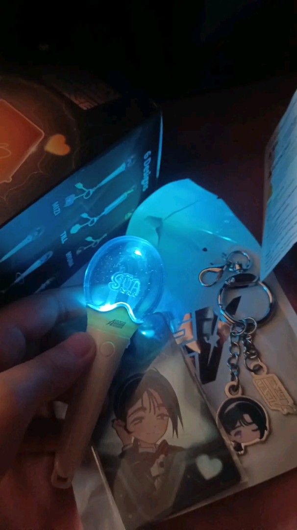 Sua Lightstick Alien stage (Category: Character Goods) located in Manila. Submitted by unlirais (Listing ID 1464024587, Image 1). Description: - K-pop lightstick with a clear bulb that lights up blue. - Features 'SUA' prominently on the lightstick. - Comes with a bonus character keychain. - Includes a photocard for fans. - Original box indicates '6 Designs' available. - A must-have collectible for any fan!.