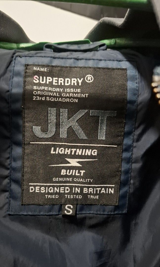 SUPERDRY Bomber Jacket (Category: Coats, Jackets and Outerwear) located in Manila. Submitted by gentleclosetcollection (Listing ID 1464058704, Image 2). Description: *Brand: Superdry *​Model / Line: Superdry Issue 23rd Squadron "Lightning" Flight Bomber Jacket *​Style Code: M50801TNS (Code: 133090) *​Tag Size: Small (S) (Fits true to size / slim fit) *Color: Navy Blue & Slate Grey *​Features: Full front zip, patches, side pockets, ribbed hem and 