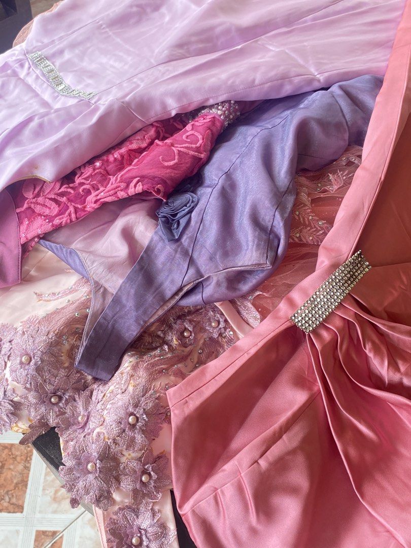 TAKE ALL 7 Assorted Gowns - Pink, Purple, Lavender (Category: Dresses) located in Davao. Submitted by alessuh (Listing ID 1463965646, Image 3). Description: - Stunning collection of formal dresses perfect for any event or party. - Includes a beautiful peach tulle gown with intricate beadwork. - Elegant purple satin gown available. - Lovely lavender and pink dresses adorned with embellishments and floral accents. - All pieces are unique and crafte