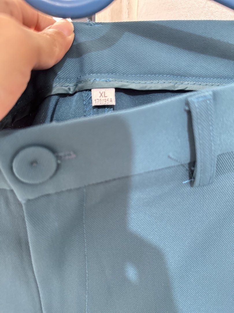 Teal Formal Trousers (Category: Trousers) located in General Trias. Submitted by keiperry_ (Listing ID 1463947562, Image 2). Description: - Teal colored formal trousers - Size XL best fit to Large - Button and zip closure at the front - Belt loops for accessories - Classic straight leg cut - Versatile for work or smart casual events - Comfortable polyester blend material.