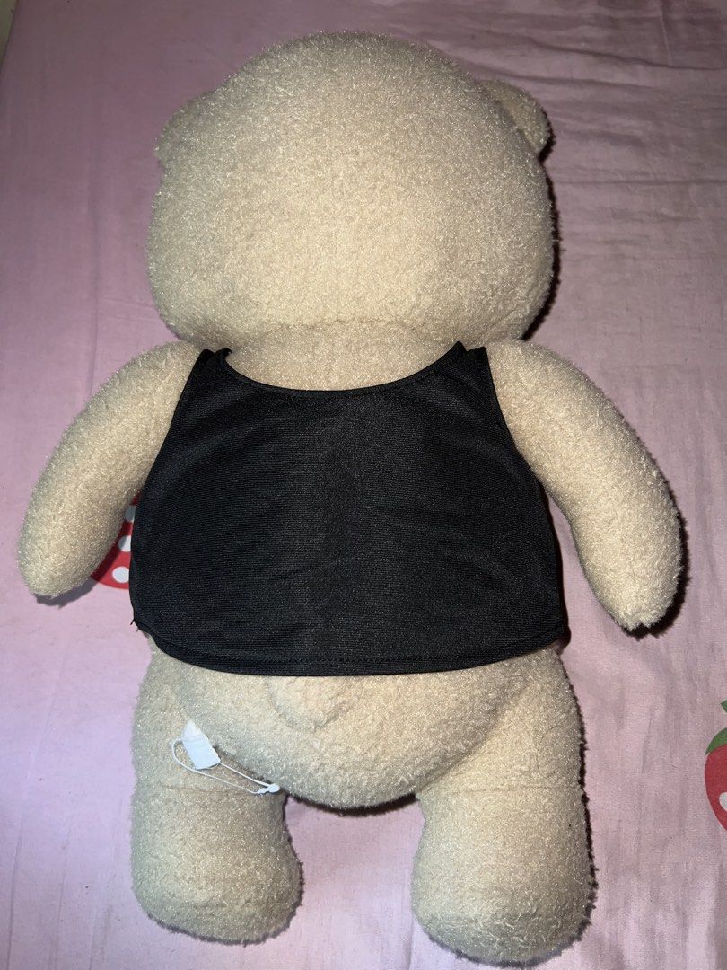 Ted 2 Teddy Bear Plush Toy (Category: Plushies & Soft Toys) located in Bulacan. Submitted by haven_plushie_dolls.888 (Listing ID 1464114748, Image 2). Description: - Ted 2 teddy bear plush - Approximately 18 inches tall - Includes black tank top with 'ted2' print - Brand new with tag still attached - Ideal for fans of the Ted movies.