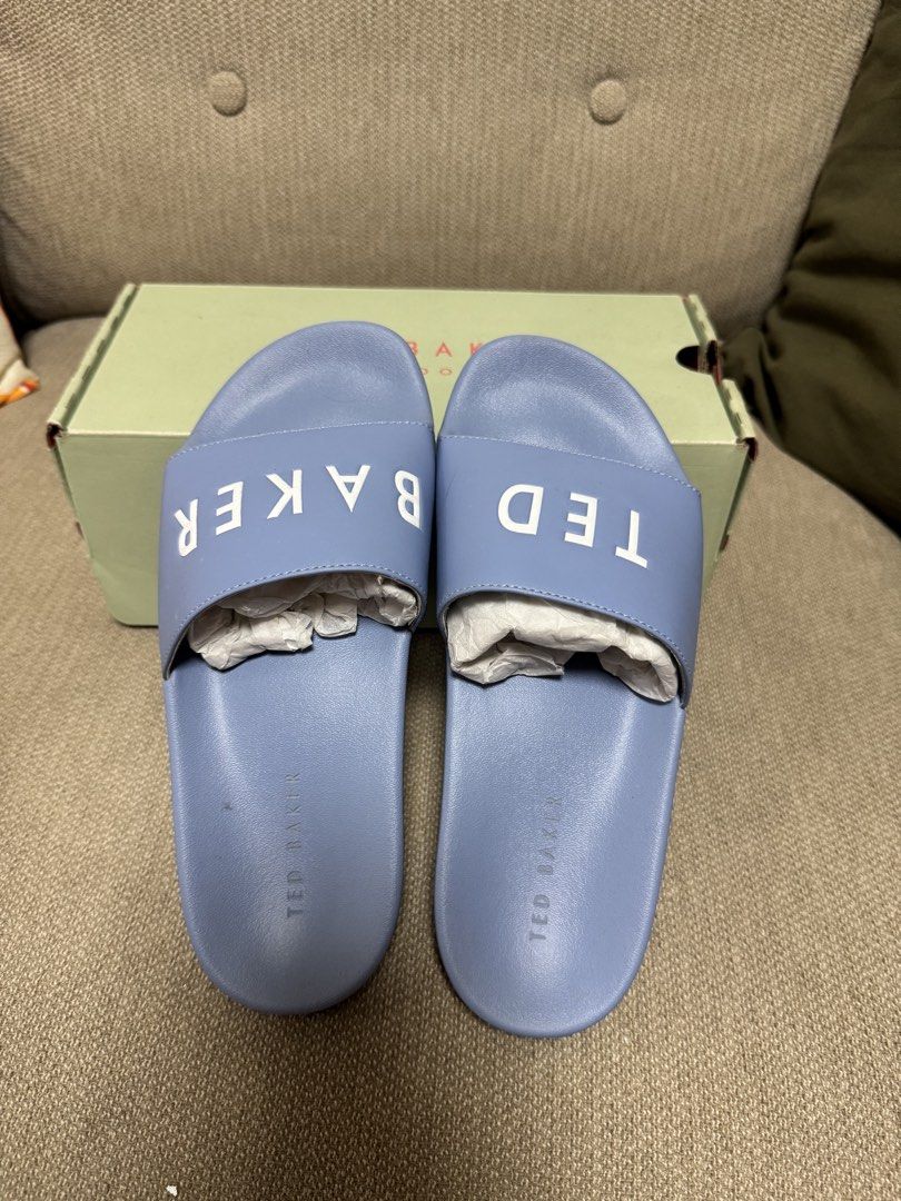 Ted Baker London Blue Slides with Box (Category: Slippers and slides) located in Muntinlupa City. Submitted by gagfl (Listing ID 1464068443, Image 3). Description: - Brand: Ted Baker London - Color: Light Blue - Features: White "TED BAKER" logo on straps - Includes: Original Ted Baker box - Ideal for: Casual wear, lounging, easy slip-on style.