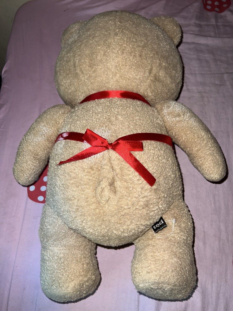 Ted Plush Toy with Bay Colony Help Apron (Category: Plushies & Soft Toys) located in Bulacan. Submitted by haven_plushie_dolls.888 (Listing ID 1464114814, Image 2). Description: - Adorable Ted plush toy - Features a red Bay Colony Help apron - Name tag clearly reads 'Ted' - Adorned with a red ribbon around its waist - Exceptionally soft and cuddly - Ideal for teddy bear collectors - Makes a wonderful gift.