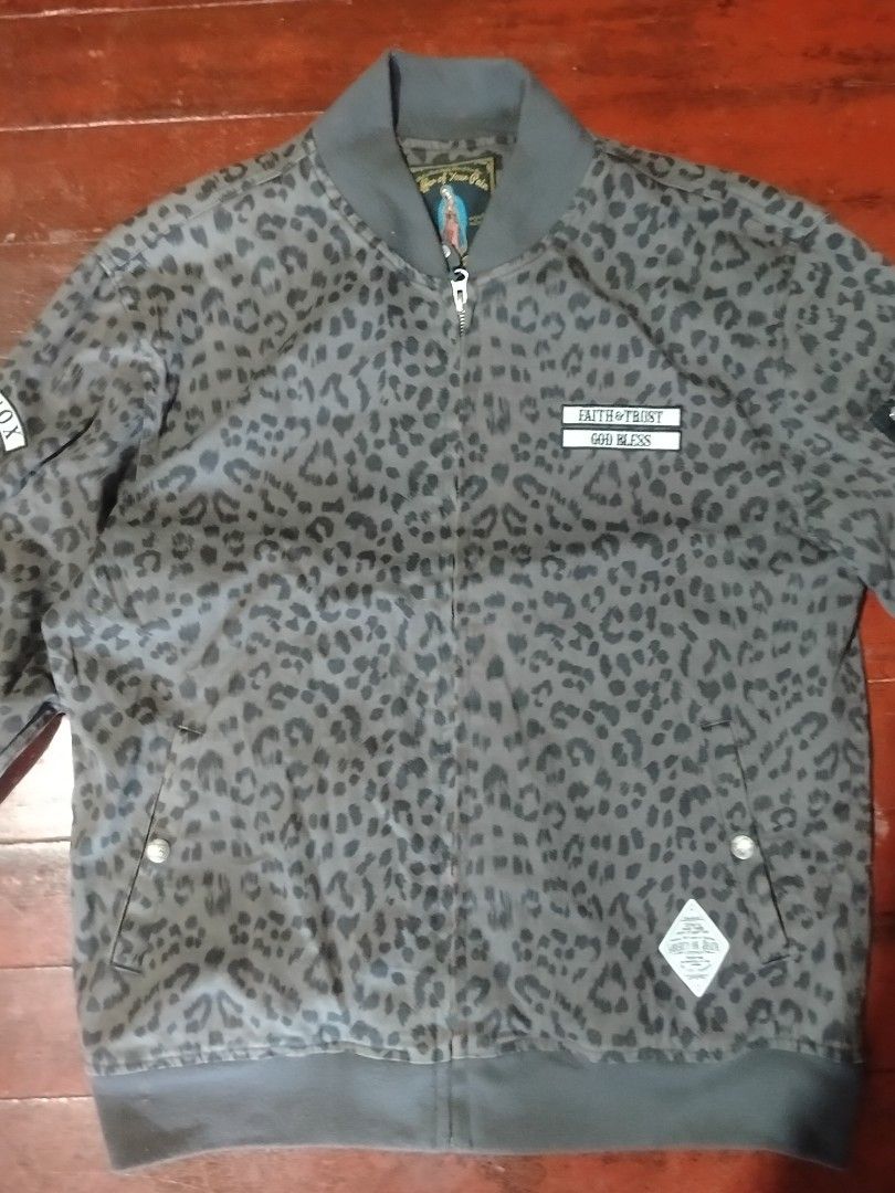 The Saintpain Leopard Print Bomber Jacket (Category: Coats, Jackets and Outerwear) located in Manila. Submitted by carlosrexc26753 (Listing ID 1463973274, Image 2). Description: - Grey leopard print bomber jacket - Brand: The Saintpain - Size: M - Features patches: "FAITH & TRUST GOD BLESS" and "THE SAINTPAIN MOXNOX" - Zipper closure - Zippered pocket on sleeve - Cool statement piece.